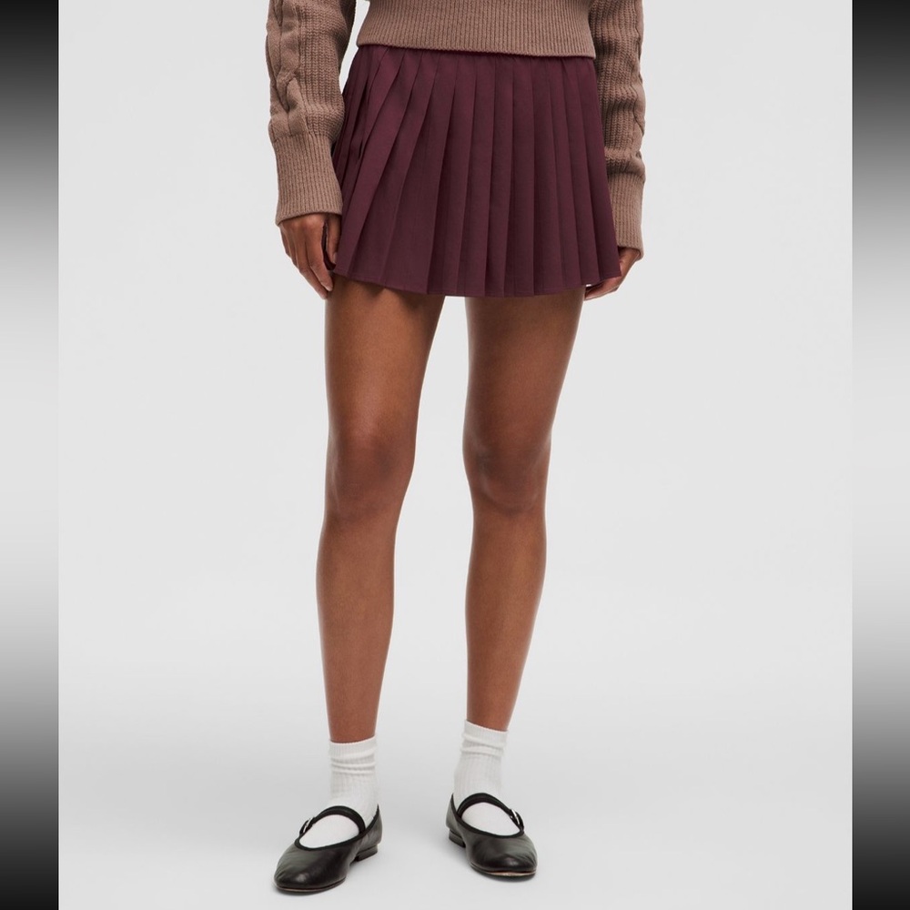 New with tags Lululemon high rise pleated tennis skirt, Garnet, size 8. Burgundy